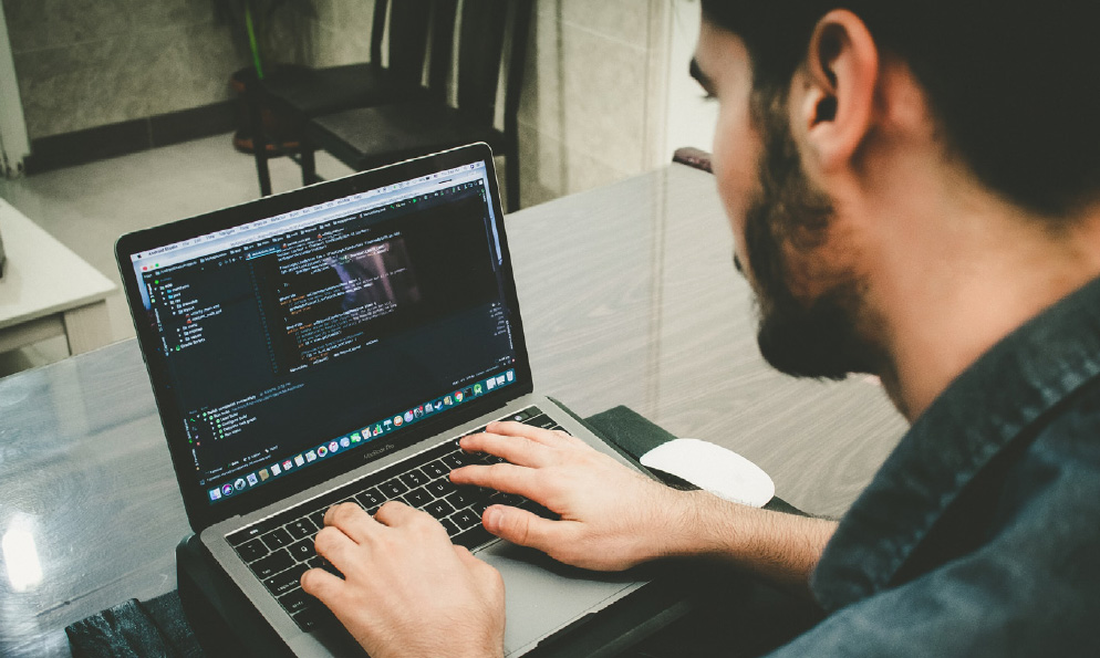 Enable operation efficiencies with AEM - man working on laptop