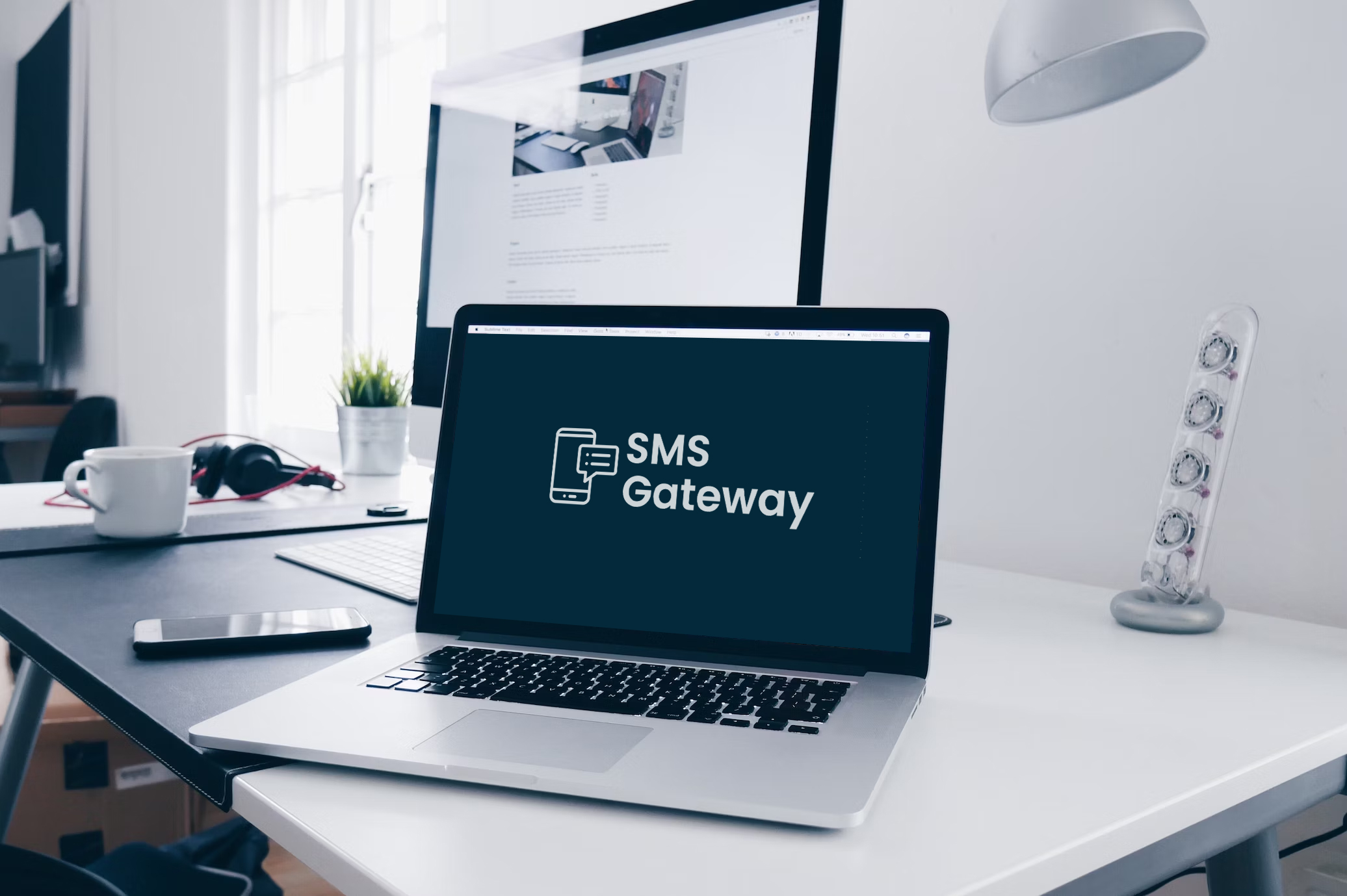 Personalized Conversational SMS at Scale with SMS Gateway image - SMS Gateway logo on laptop