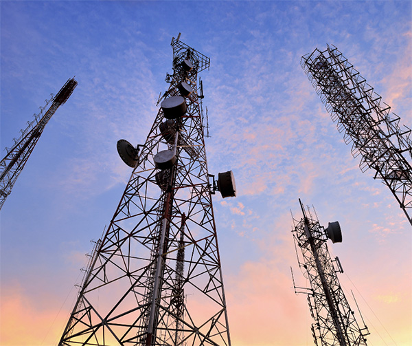 Telecommunications pylons against a blue/pink sky